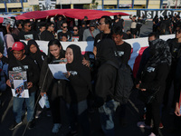 Hundreds of family members of tragedy victims read demands for legal justice to the Indonesian government in front of the stadium, during co...