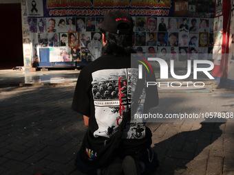 A supporter of Arema FC is praying at the 13th gate of the stadium while commemorating the first anniversary of the Kanjuruhan tragedy, whic...