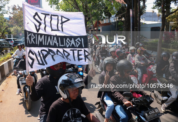 Thousands of Arema FC supporters convoy on the streets, during the 1st anniversary of the Kanjuruhan tragedy which killed 135 football suppo...