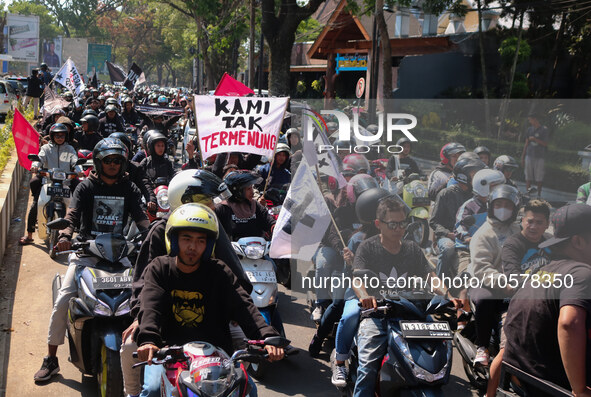 Thousands of Arema FC supporters convoy on the streets, during the 1st anniversary of the Kanjuruhan tragedy which killed 135 football suppo...