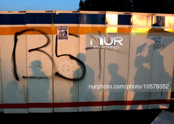 Shadows of Arema FC supporters are seen on the boards during the renovation of the stadium on the first anniversary of the Kanjuruhan traged...