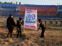 Supporters of Arema FC are putting up photos of the victims in the goal area of the field, during the first anniversary of the Kanjuruhan tr...