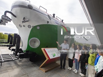 A staff member introduces a model of the ''Striver'' to students at the Taizhou Science and Technology Museum in Taizhou, Jiangsu province,...