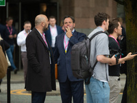 Harry Cole, political editor of The Sun, talks to Henry Hill of Conservative Home, as Owen Jones tries to interview delegatesduring the Cons...