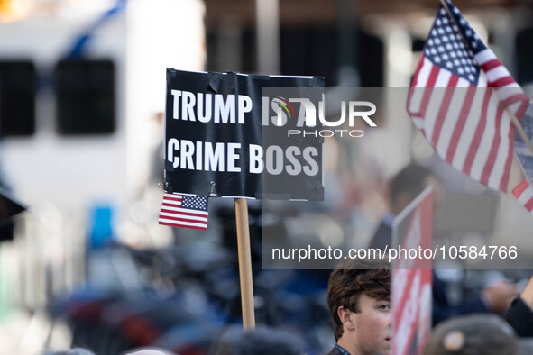 A sign is held in protest of Donald Trump outside the New York Supreme Court where Donald Trump faces trial in a civic court case brought by...