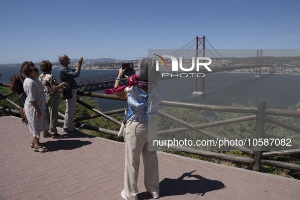 Tourists are seen walking around the vicinity of the viewpoint near the monument of Christ the King in Almada, Lisbon. 04 September 2023. Th...