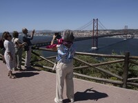 Tourists are seen walking around the vicinity of the viewpoint near the monument of Christ the King in Almada, Lisbon. 04 September 2023. Th...