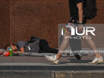 EDMONTON, CANADA - SEPTEMBER 29, 2023:
A homeless woman sleeping on the street in downtown Edmonton, on September 29, 2023, in Edmonton, Alb...