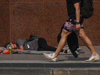 EDMONTON, CANADA - SEPTEMBER 29, 2023:
A homeless woman sleeping on the street in downtown Edmonton, on September 29, 2023, in Edmonton, Alb...