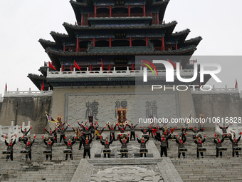 Students practice the ''Battle drum of the Qin and Han Dynasties'' below the Wei River in Xianyang City, Shaanxi Province, China, Oct 8, 202...