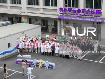 Doctors, nurses and volunteers hold a ceremony at Shaoxing Central Hospital to celebrate the completion of the task of providing medical car...