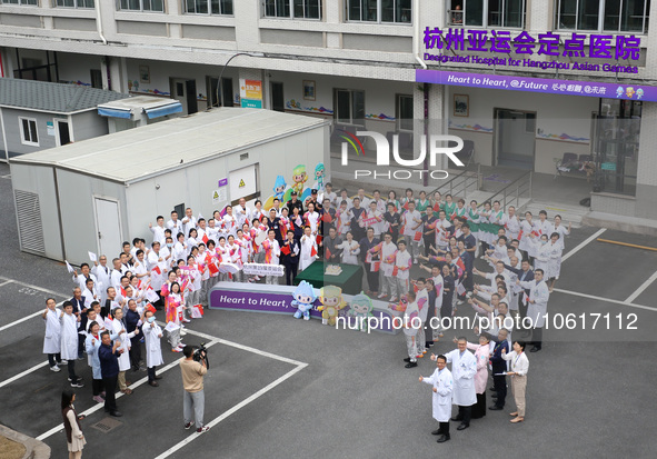 Doctors, nurses and volunteers hold a ceremony at Shaoxing Central Hospital to celebrate the completion of the task of providing medical car...