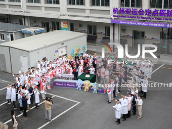 Doctors, nurses and volunteers hold a ceremony at Shaoxing Central Hospital to celebrate the completion of the task of providing medical car...