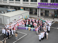 Doctors, nurses and volunteers hold a ceremony at Shaoxing Central Hospital to celebrate the completion of the task of providing medical car...