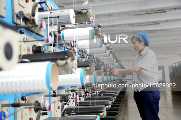 LIANYUNGANG, CHINA - OCTOBER 12, 2023 - A worker works at a workshop of a new materials company in Lianyungang, East China's Jiangsu Provinc...