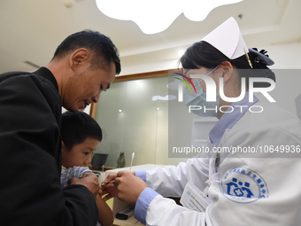 GUIYANG, CHINA - OCTOBER 17, 2023 - A medical worker inoculates children with China's first quadrivalent subunit influenza vaccine at a comm...