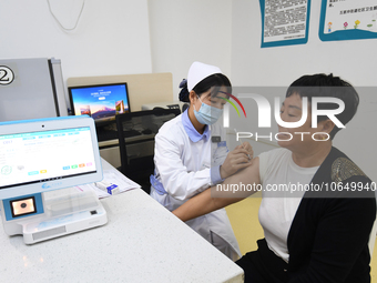 GUIYANG, CHINA - OCTOBER 17, 2023 - A medical worker inoculates people with China's first quadrivalent subunit influenza vaccine at a commun...