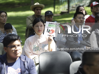 October 25, 2023, Mexico City, Mexico: Attendees of the China Cultural Festival in Los Pinos show posters in support of those affected in Ac...