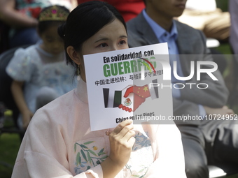 October 25, 2023, Mexico City, Mexico: Attendees of the China Cultural Festival in Los Pinos show posters in support of those affected in Ac...