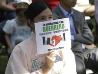 October 25, 2023, Mexico City, Mexico: Attendees of the China Cultural Festival in Los Pinos show posters in support of those affected in Ac...