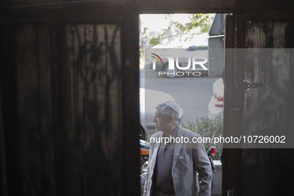 An Iranian-Jewish man stands at the door of a synagogue in downtown Tehran during a gathering to protest against the Israeli attacks on Pale...