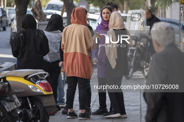 Young Iranian-Jewish women stand together out of a synagogue in downtown Tehran during a gathering to protest against Israeli attacks on Pal...