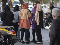 Young Iranian-Jewish women stand together out of a synagogue in downtown Tehran during a gathering to protest against Israeli attacks on Pal...