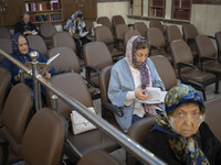 Iranian-Jewish women read Hebrew Bibles while sitting at a synagogue in downtown Tehran before a gathering to protest against Israeli attack...