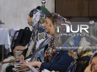 Iranian-Jewish women sit at a synagogue in downtown Tehran while taking part in a gathering to protest against Israeli attacks on Palestinia...