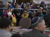 A young Iranian-Jewish woman looks on as she sits at a synagogue in downtown Tehran while taking part in a gathering to protest against Isra...