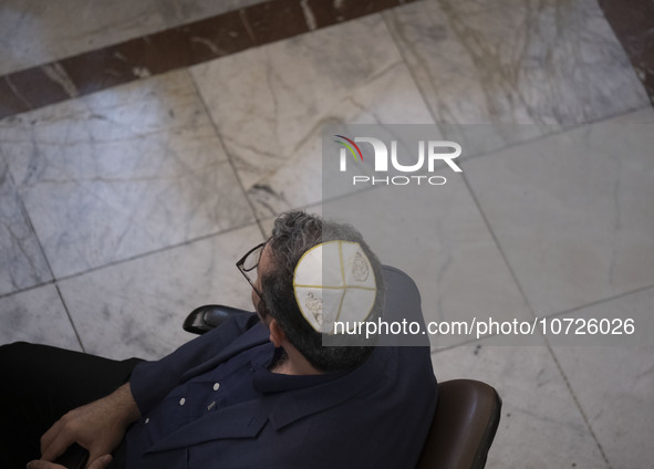 An Iranian-Jewish man sits at a synagogue in downtown Tehran during a gathering to protest against Israeli attacks on Palestinian civilians,...