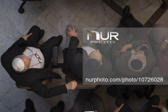 Iranian-Jewish men sit at a synagogue in downtown Tehran during a gathering to protest against Israeli attacks on Palestinian civilians, Oct...