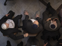 Iranian-Jewish men sit at a synagogue in downtown Tehran during a gathering to protest against Israeli attacks on Palestinian civilians, Oct...