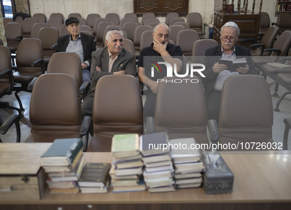 An Iranian-Jewish man reads a Hebrew Bible while sitting at a synagogue in downtown Tehran during a gathering to protest against Israeli att...