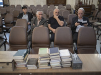 An Iranian-Jewish man reads a Hebrew Bible while sitting at a synagogue in downtown Tehran during a gathering to protest against Israeli att...