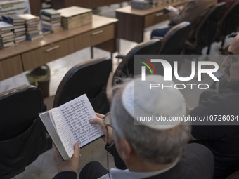 An Iranian-Jewish man reads a Hebrew Bible while sitting at a synagogue in downtown Tehran during a gathering to protest against Israeli att...