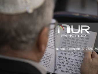 An Iranian-Jewish man reads a Hebrew Bible while sitting at a synagogue in downtown Tehran during a gathering to protest against Israeli att...