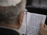 An Iranian-Jewish man reads a Hebrew Bible while sitting at a synagogue in downtown Tehran during a gathering to protest against Israeli att...