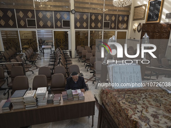 An Iranian-Jewish man reads a Hebrew Bible while sitting at a synagogue in downtown Tehran during a gathering to protest against Israeli att...