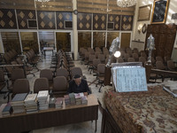 An Iranian-Jewish man reads a Hebrew Bible while sitting at a synagogue in downtown Tehran during a gathering to protest against Israeli att...