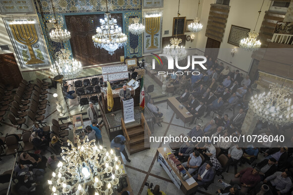 Iranian-Jewish men sit at a synagogue in downtown Tehran while taking part in a gathering to protest against Israeli attacks on Palestinian...