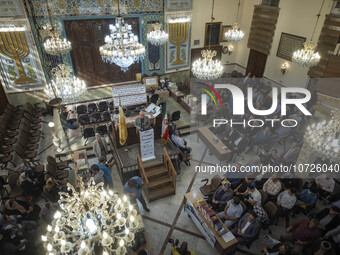 Iranian-Jewish men sit at a synagogue in downtown Tehran while taking part in a gathering to protest against Israeli attacks on Palestinian...