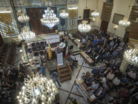 Iranian-Jewish men sit at a synagogue in downtown Tehran while taking part in a gathering to protest against Israeli attacks on Palestinian...