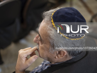 An Iranian-Jewish man sits at a synagogue in downtown Tehran during a gathering to protest against Israeli attacks on Palestinian civilians,...