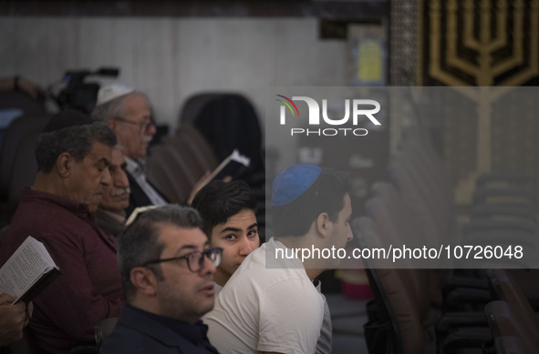 An Iranian-Jewish man looks on while sitting at a synagogue in downtown Tehran during a gathering to protest against Israeli attacks on Pale...