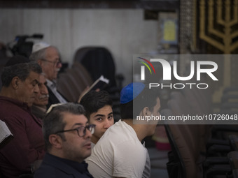 An Iranian-Jewish man looks on while sitting at a synagogue in downtown Tehran during a gathering to protest against Israeli attacks on Pale...