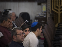 An Iranian-Jewish man looks on while sitting at a synagogue in downtown Tehran during a gathering to protest against Israeli attacks on Pale...