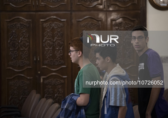 Iranian-Jewish men stand at a synagogue in downtown Tehran during a gathering to protest against Israeli attacks on Palestinian civilians, O...