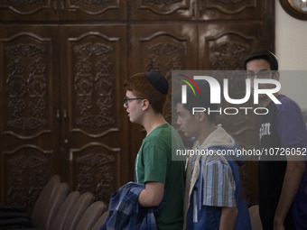 Iranian-Jewish men stand at a synagogue in downtown Tehran during a gathering to protest against Israeli attacks on Palestinian civilians, O...