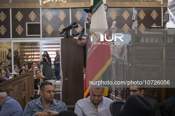 Rabbi Younes Hamami Lalehzar (top), Leader of Iranian Jews, delivers a speech as he stands next to an Iran flag at a synagogue in downtown T...